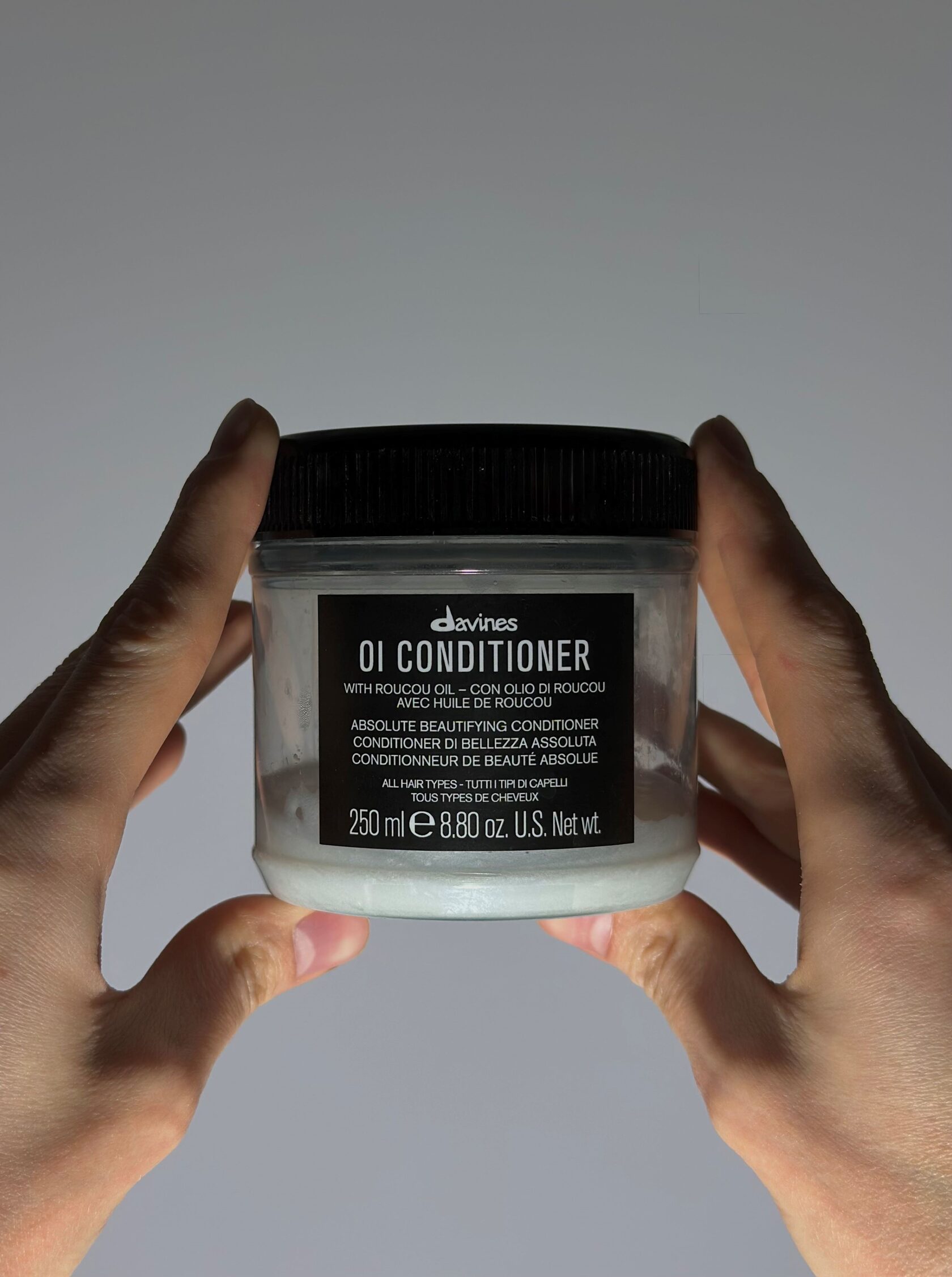 Hands holding a skincare jar